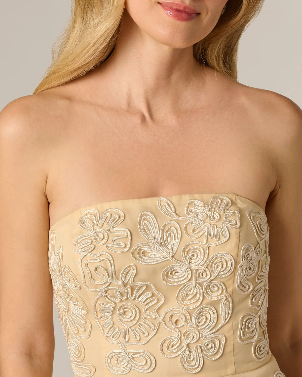 Pale yellow strapless bodice with raised floral embroidery detail