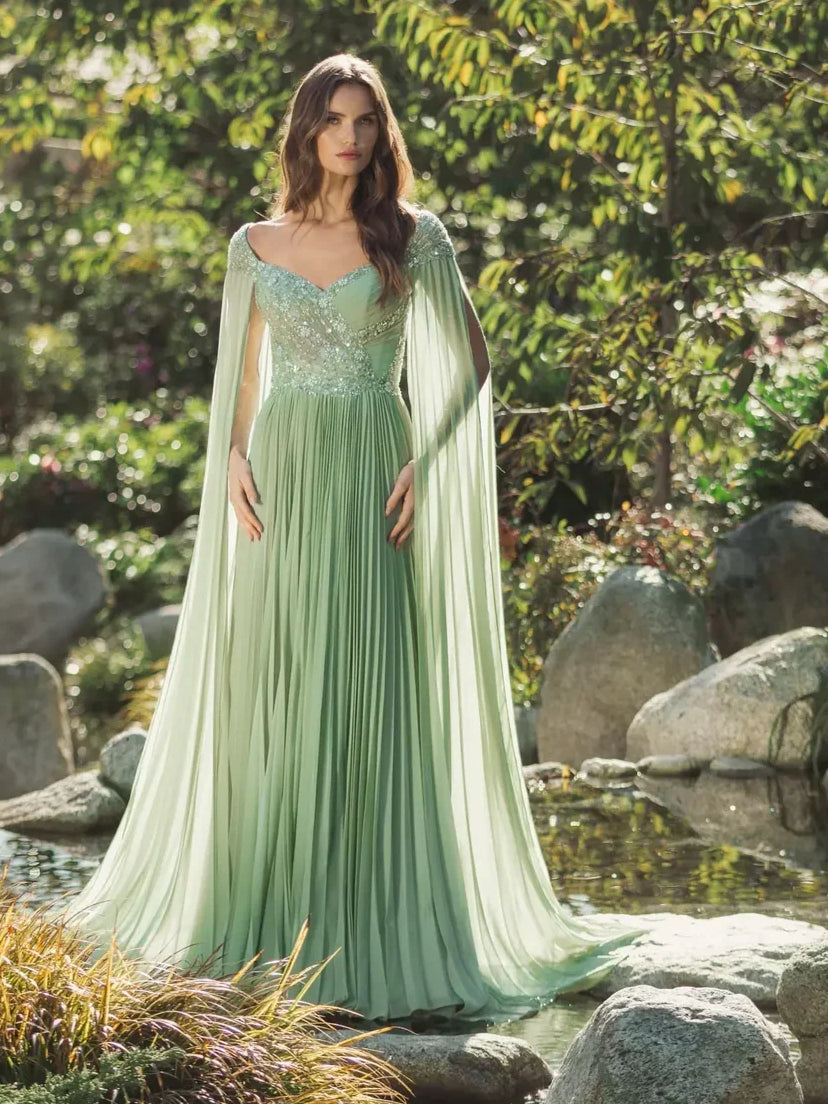 Dusty sage sweetheart formal dress with beaded bodice, pleated floor-length skirt, cape