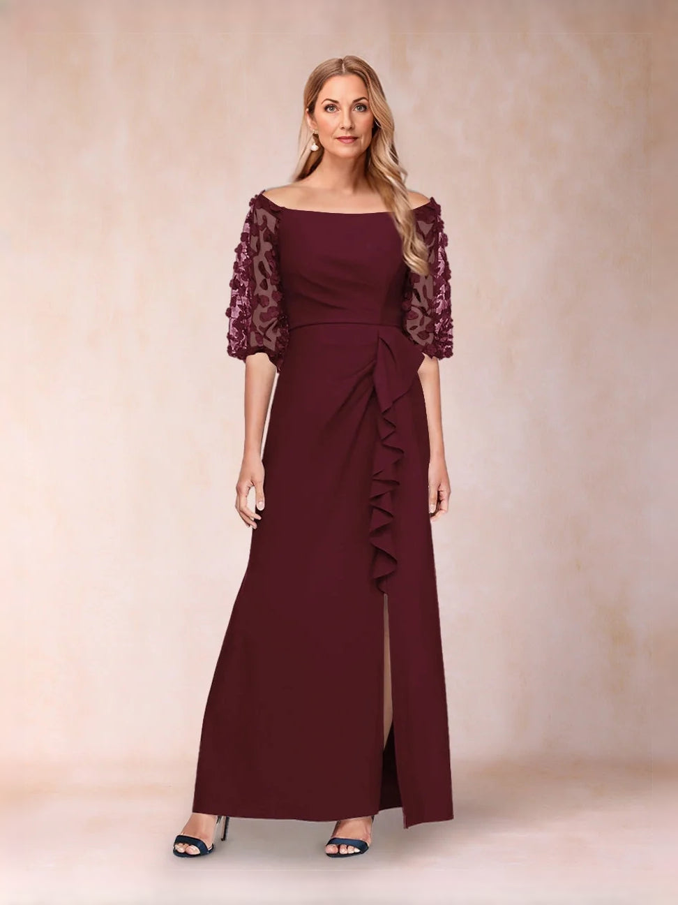 Off-shoulder deep red formal gown with lace sleeves, fitted bodice, and side-slit skirt