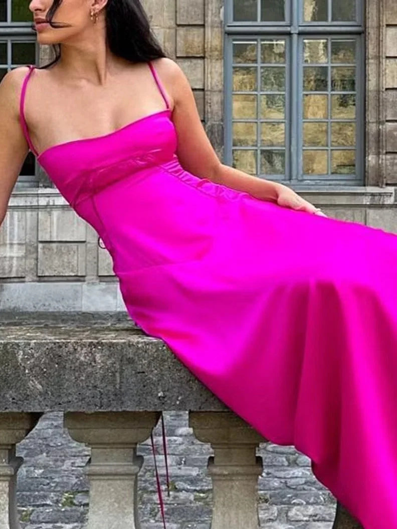Hot pink satin prom dress with square neckline, thin straps, and flowing A-line skirt.