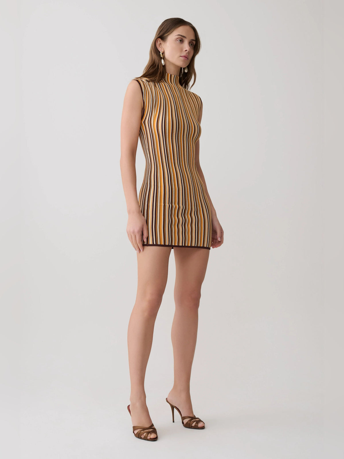 Sleeveless mini dress with tall vertical stripe design in brown and cream, mock neck