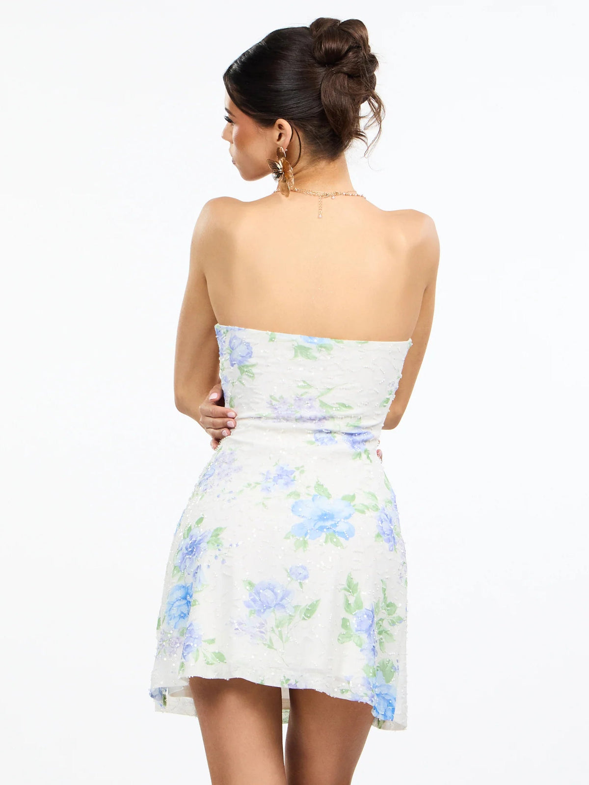 Back view of floral strapless A-line mini dress with strapless straight back