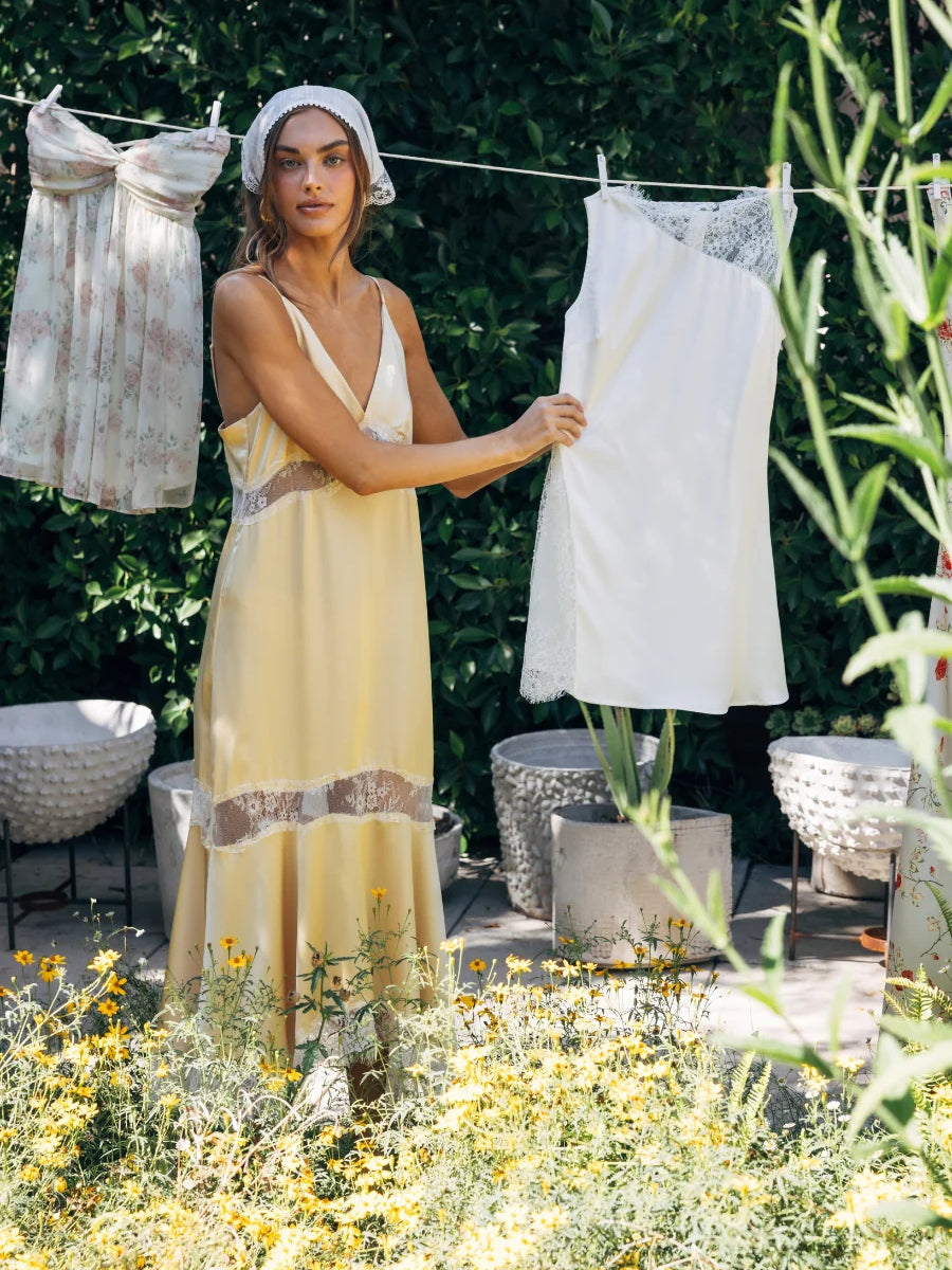 Yellow satin midi slip dress with lace hem panels and V-neck, front view