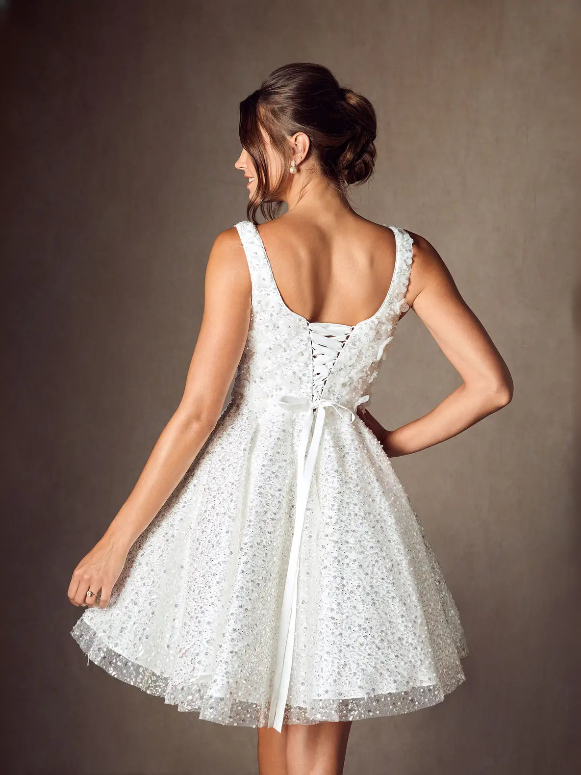 White square-neck A-line mini wedding dress from back with lace-up corset detail