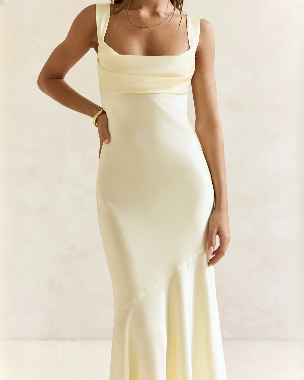 Sleeveless satin A-line maxi dress in pale yellow, close-up of square neckline and waist