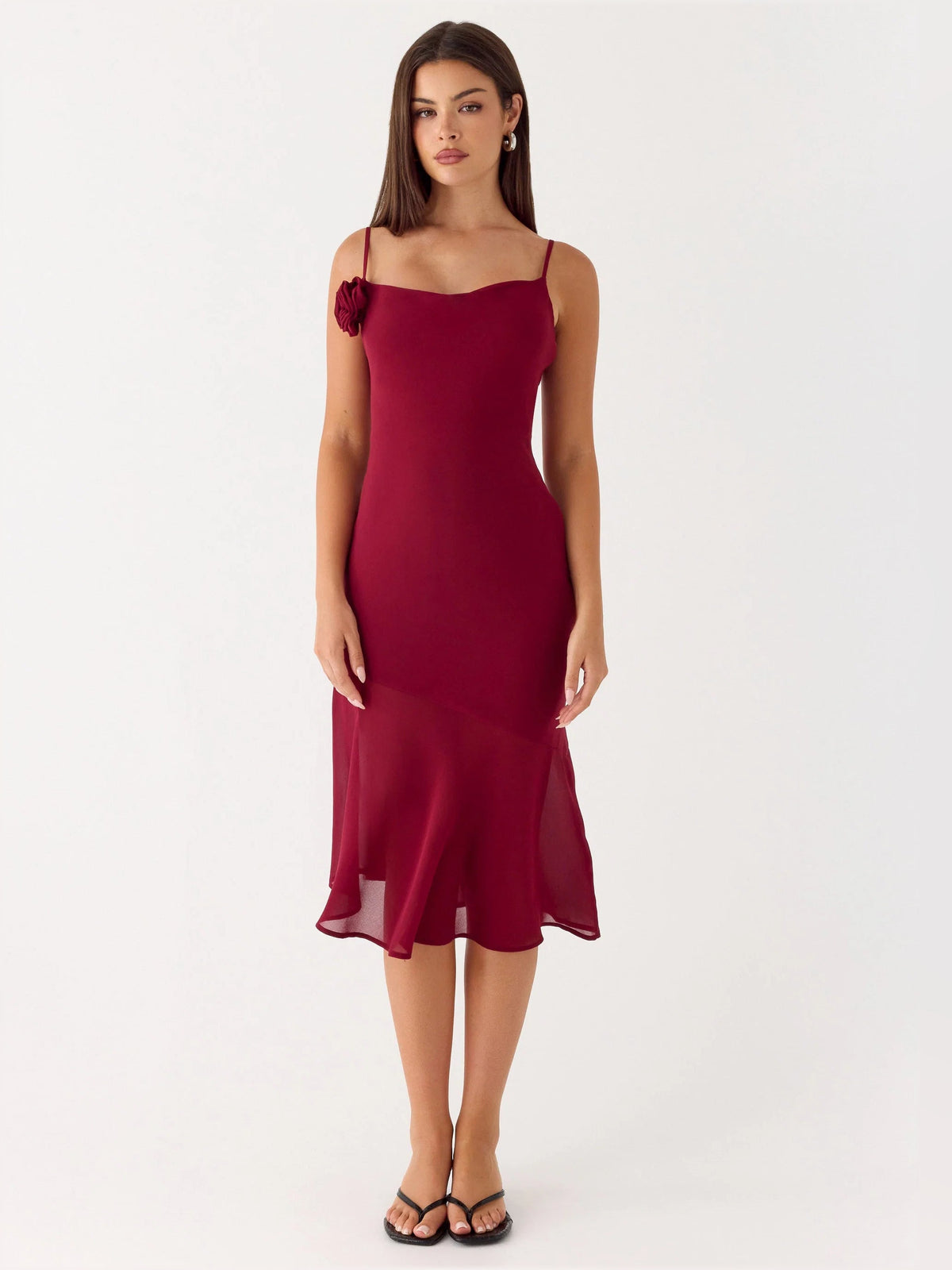 Red midi formal dress with spaghetti straps, fitted silhouette, rosette detail on shoulder