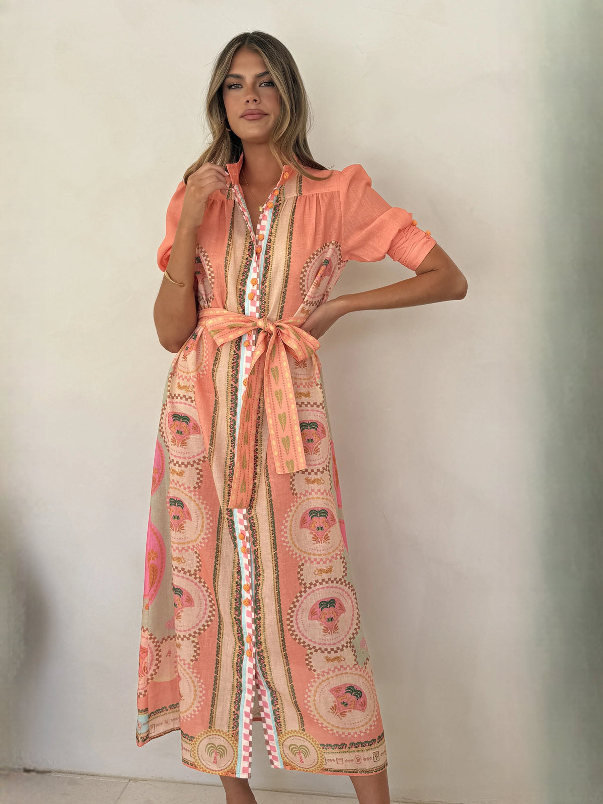Peach midi formal dress with medallion print, tie waist, and draped collar