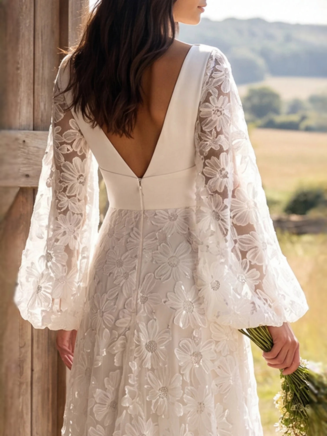 Ivory wedding dress with deep V neckline, open back detail, and lace long sleeves