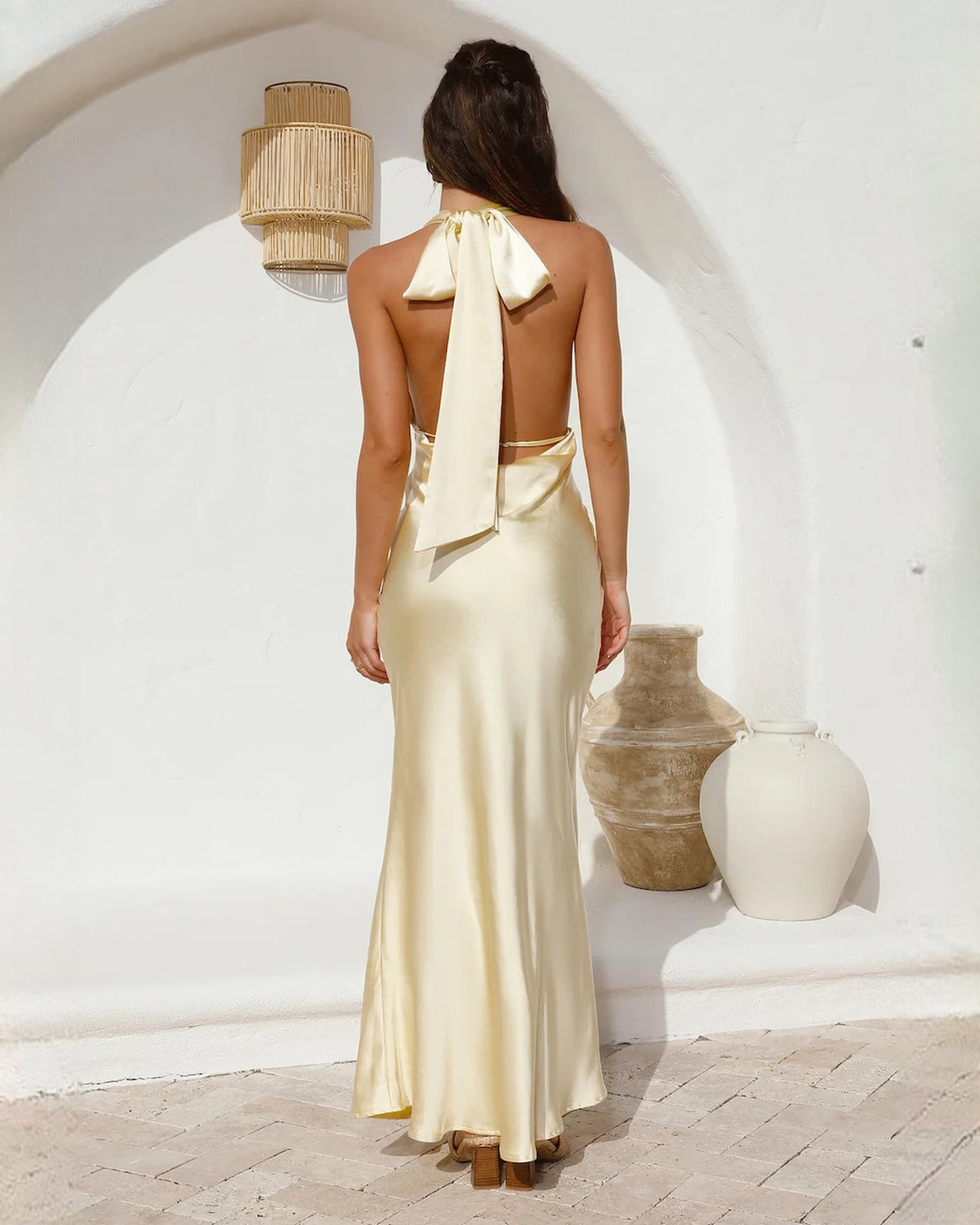 Ivory satin sleeveless A-line maxi gown, open back with ribbon bow and low back cut