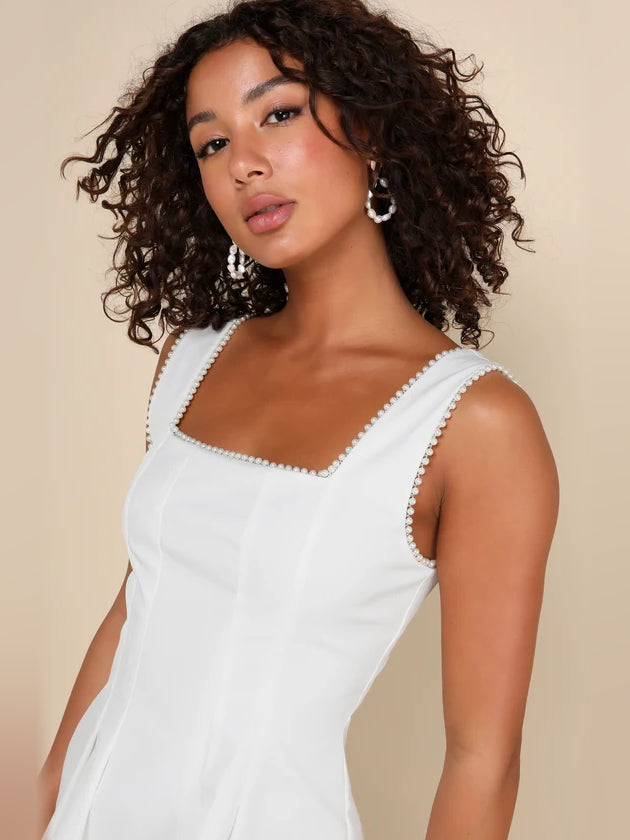 White square-neck mini dress close-up with sleeveless beaded neckline trim