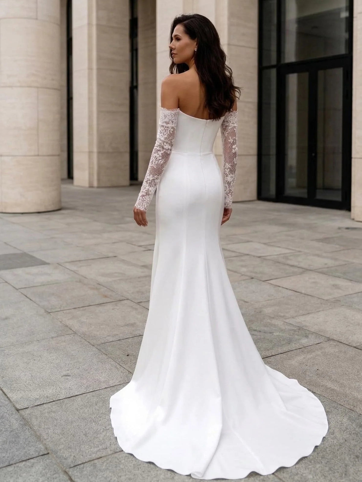 Ivory mermaid wedding dress with lace sleeves and draped floor-length skirt