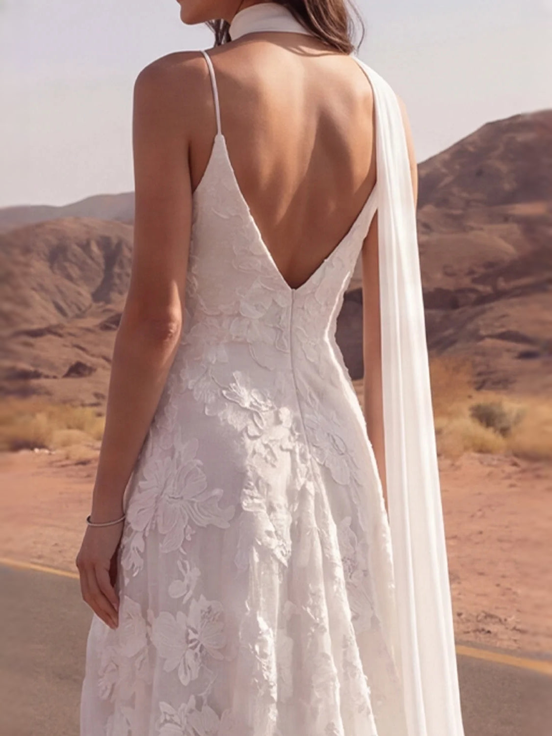 Ivory V-neck A-line wedding dress with open back and trailing veil