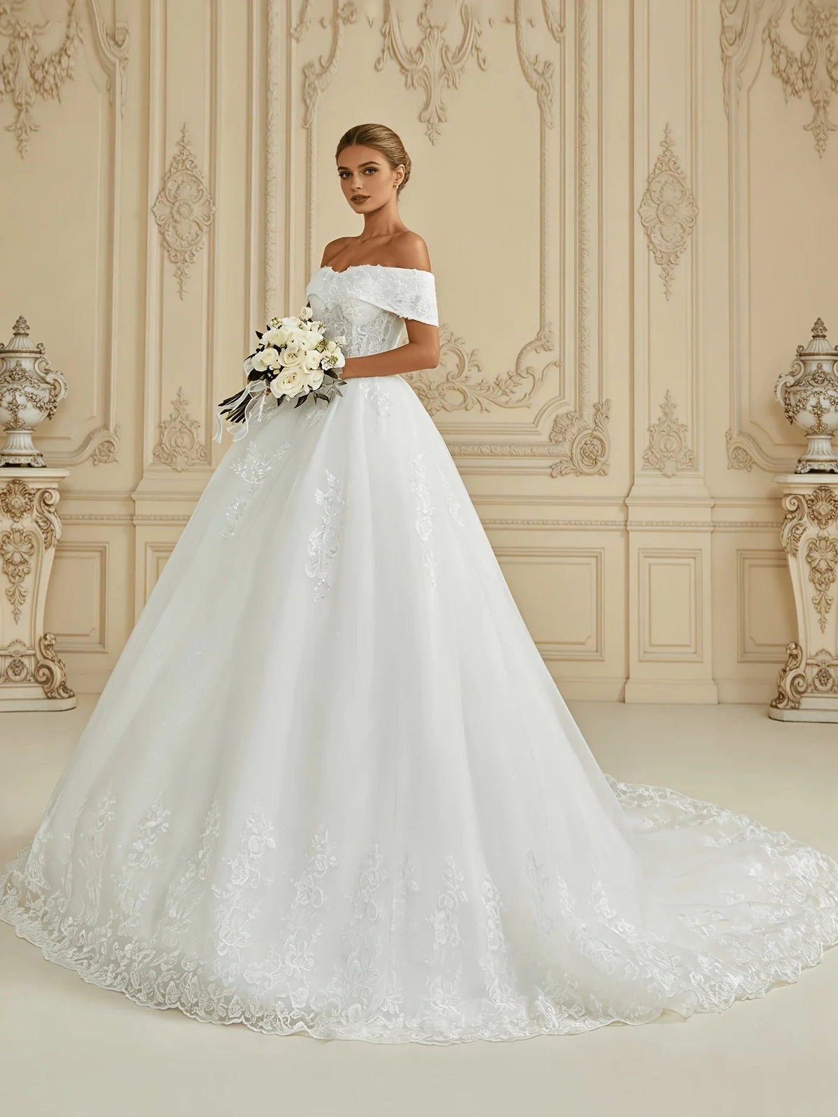 Ivory off-shoulder ball gown wedding dress with layered tulle skirt and bouquet