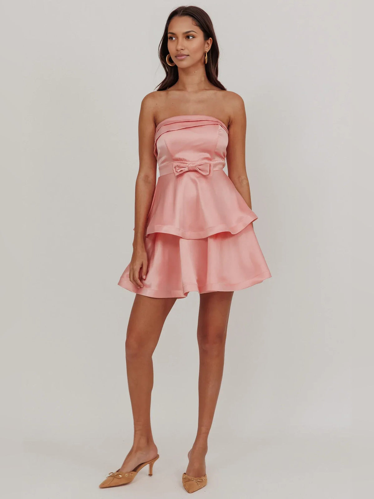 Pink strapless satin homecoming mini dress with tiered flared ruffles and bow