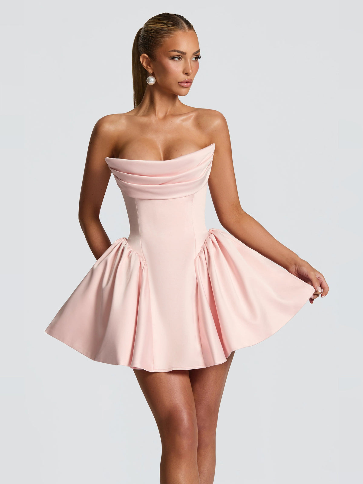 Blush strapless mini dress with draped bust and voluminous pleated skirt