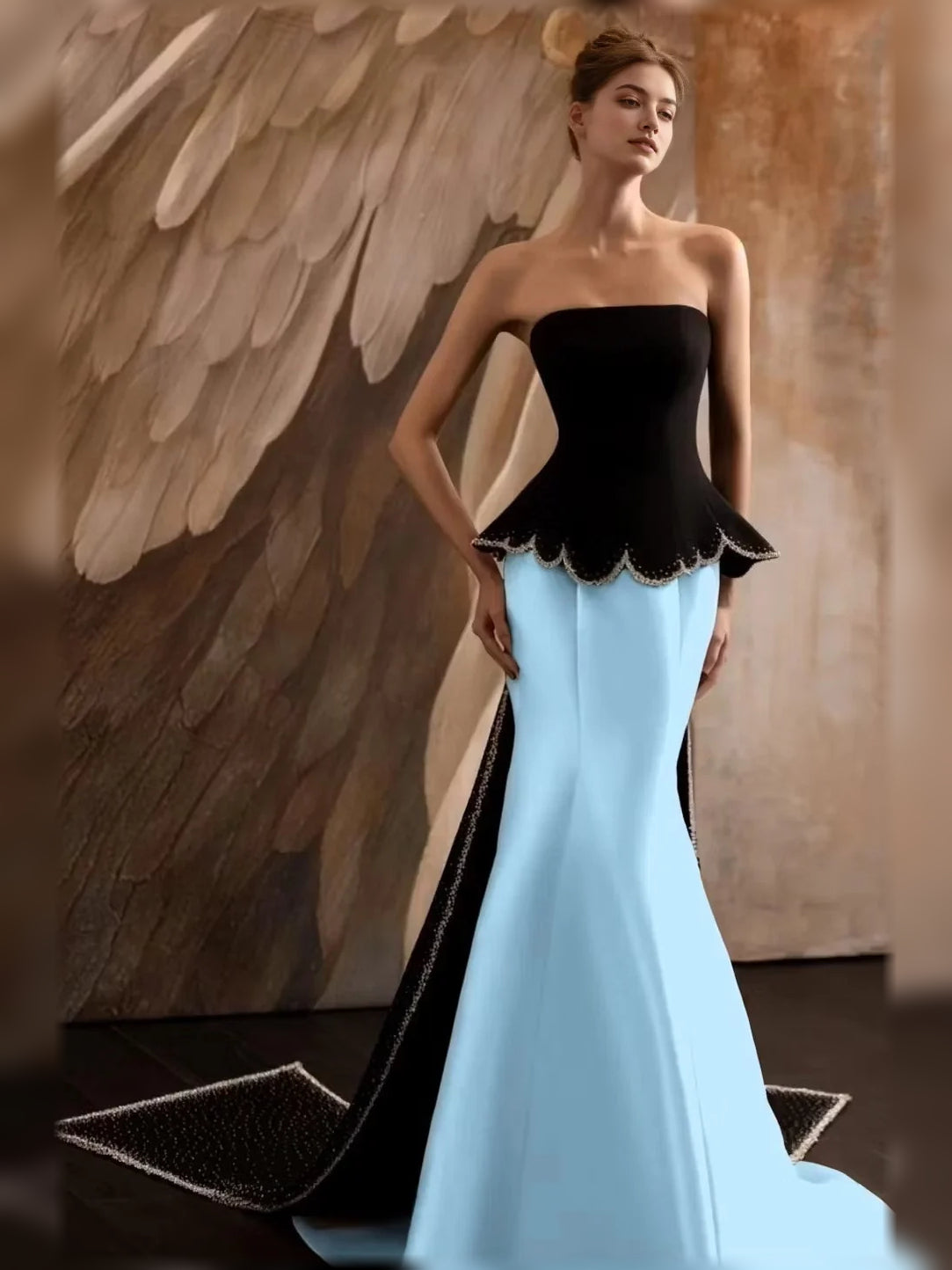 Strapless mermaid formal dress with black bodice, scalloped peplum, light blue skirt.