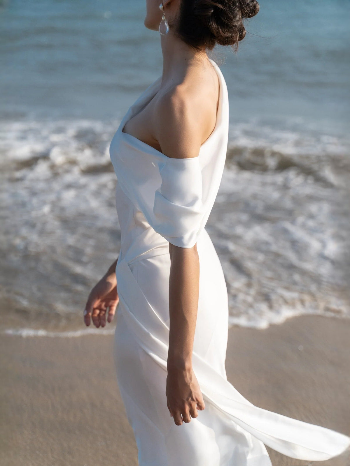 Ivory satin one-shoulder sheath wedding dress, draped neckline and open back, floor-length
