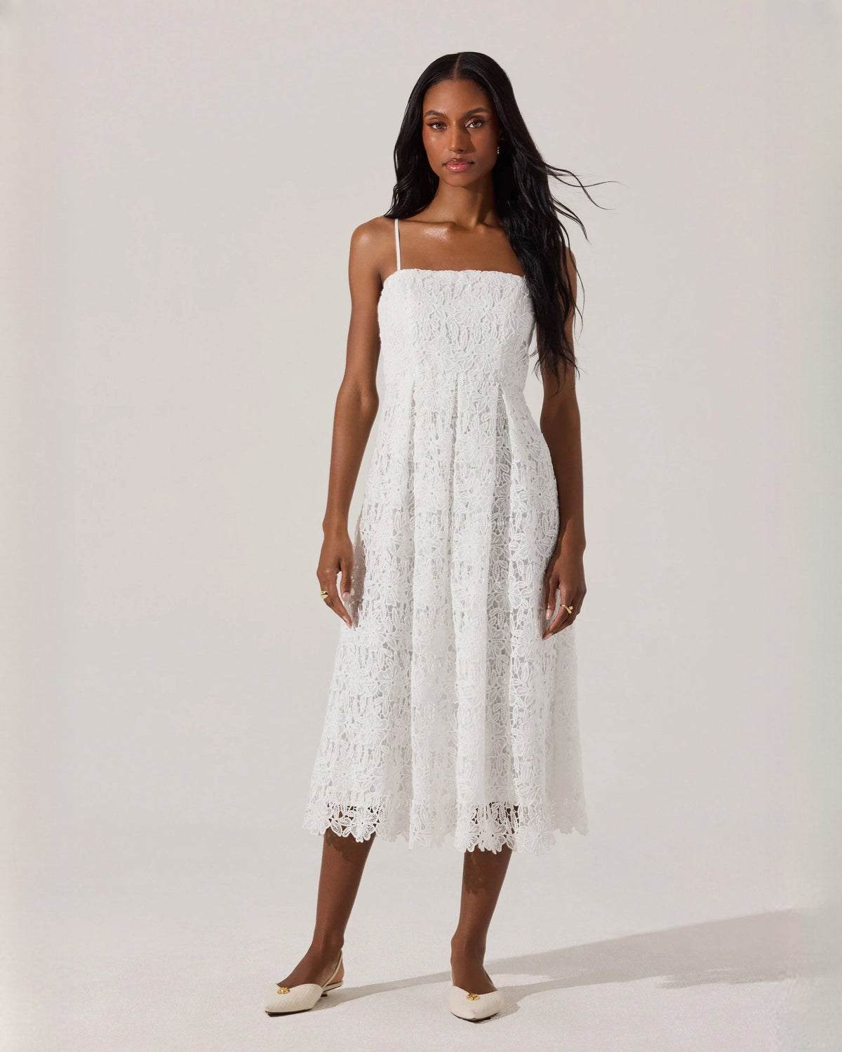 White sleeveless A-line midi dress with square neckline, spaghetti straps, lace edging