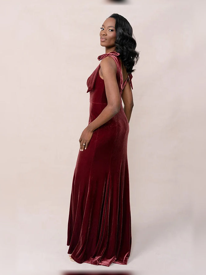Burgundy velvet mermaid dress with square neckline, sleeveless, side view, floor length.