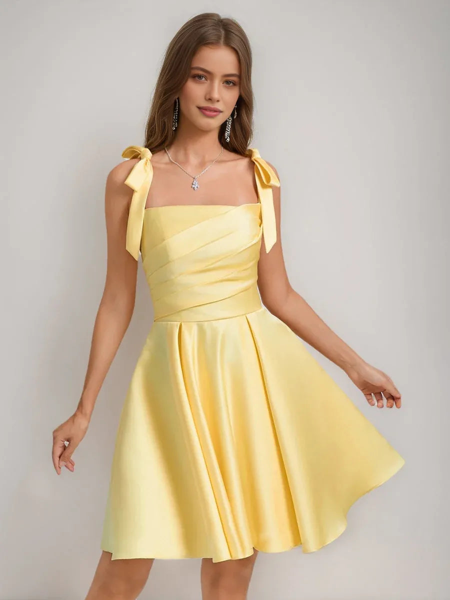 Yellow satin corset-style square neck A-line short dress with bow shoulder accents.