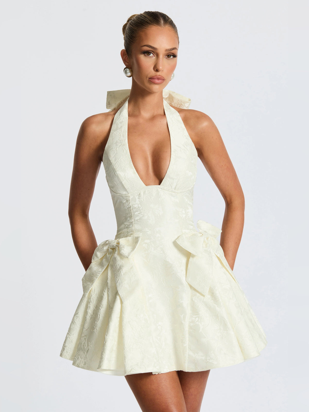 Ivory halter mini dress with deep V neckline and gathered bow waist