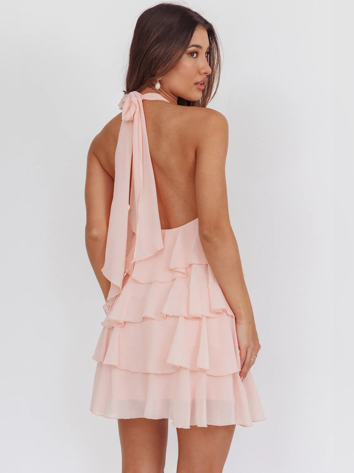 Pink halter back mini dress with tied halter strap and tiered ruffle skirt