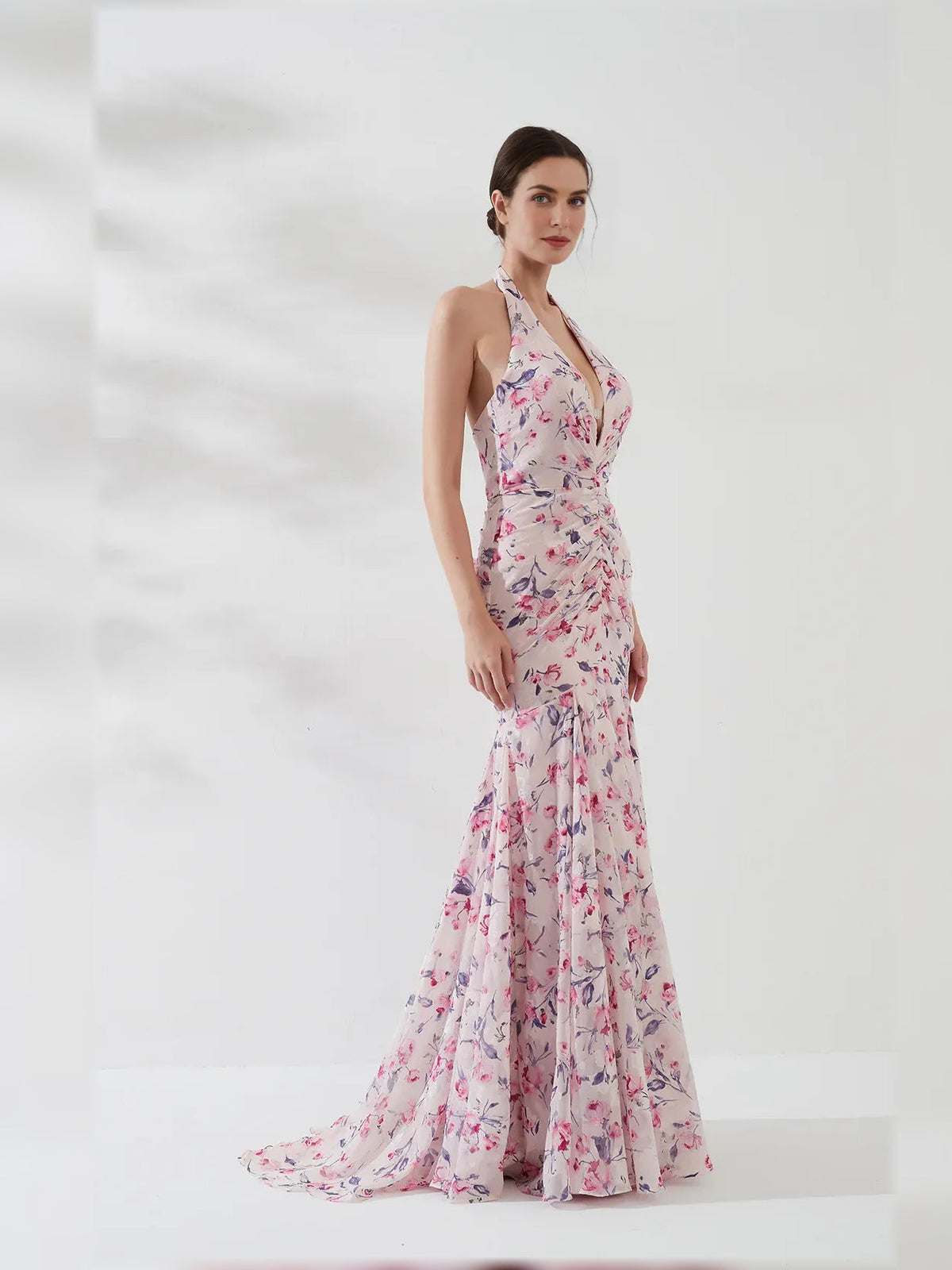 Floral halter neck formal dress with ruched bodice and flowing floor-length skirt