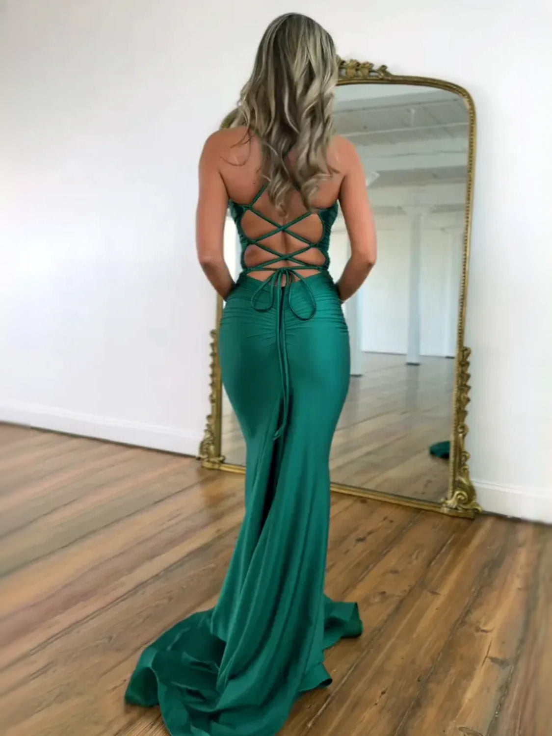 Teal ruched prom dress with crisscross back straps and plunging back neckline