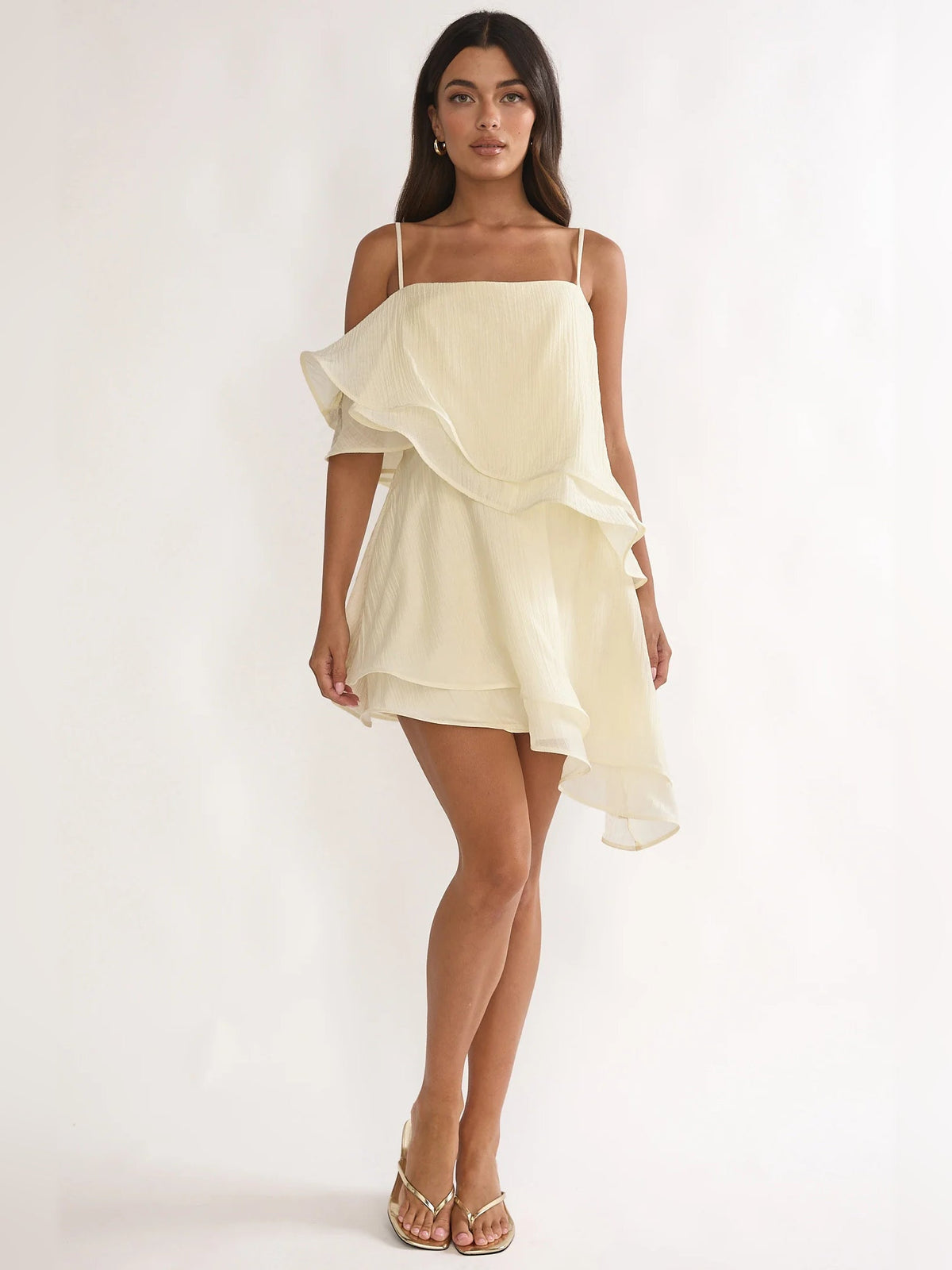 Cream layered mini dress with ruffle tiers and asymmetrical hem