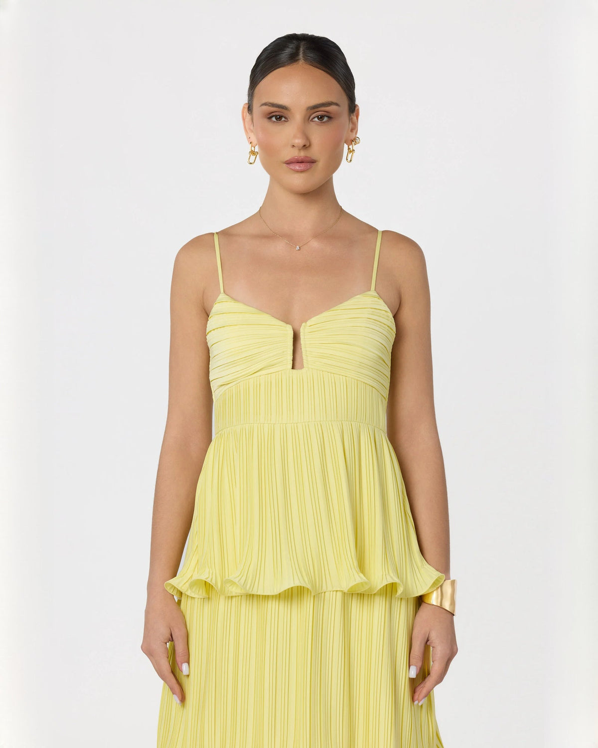 Light yellow sleeveless tiered maxi dress with V-neckline and gathered bodice