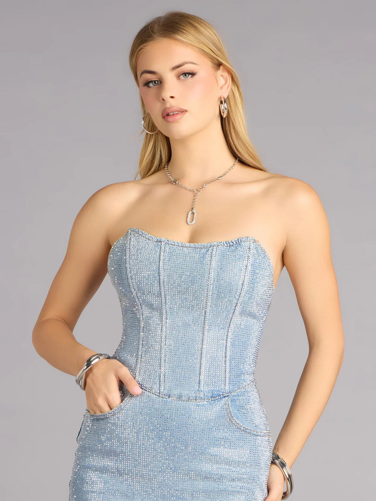 Teal rhinestone strapless mini dress with corset-style bodice and center seam detail