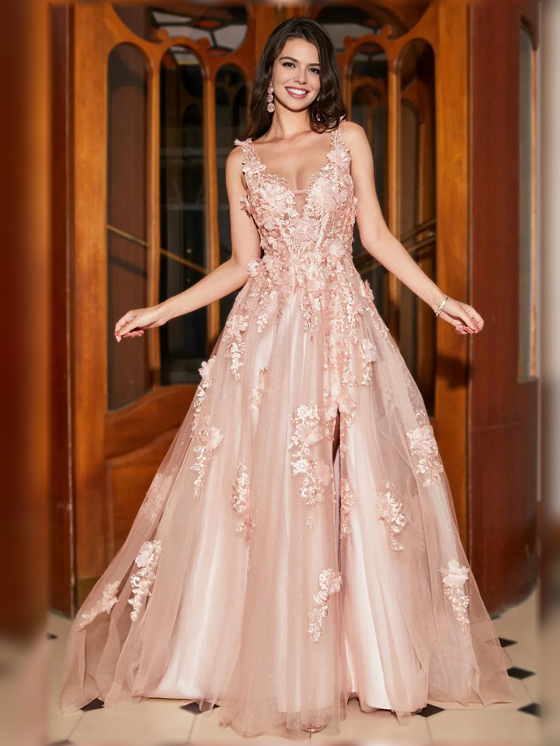 Light pink floral V-neck formal gown with fitted bodice, flowing skirt, and thigh-high slit