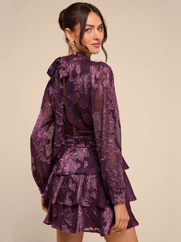 Purple floral tiered mini dress with high neckline and long bell sleeves, tiered back