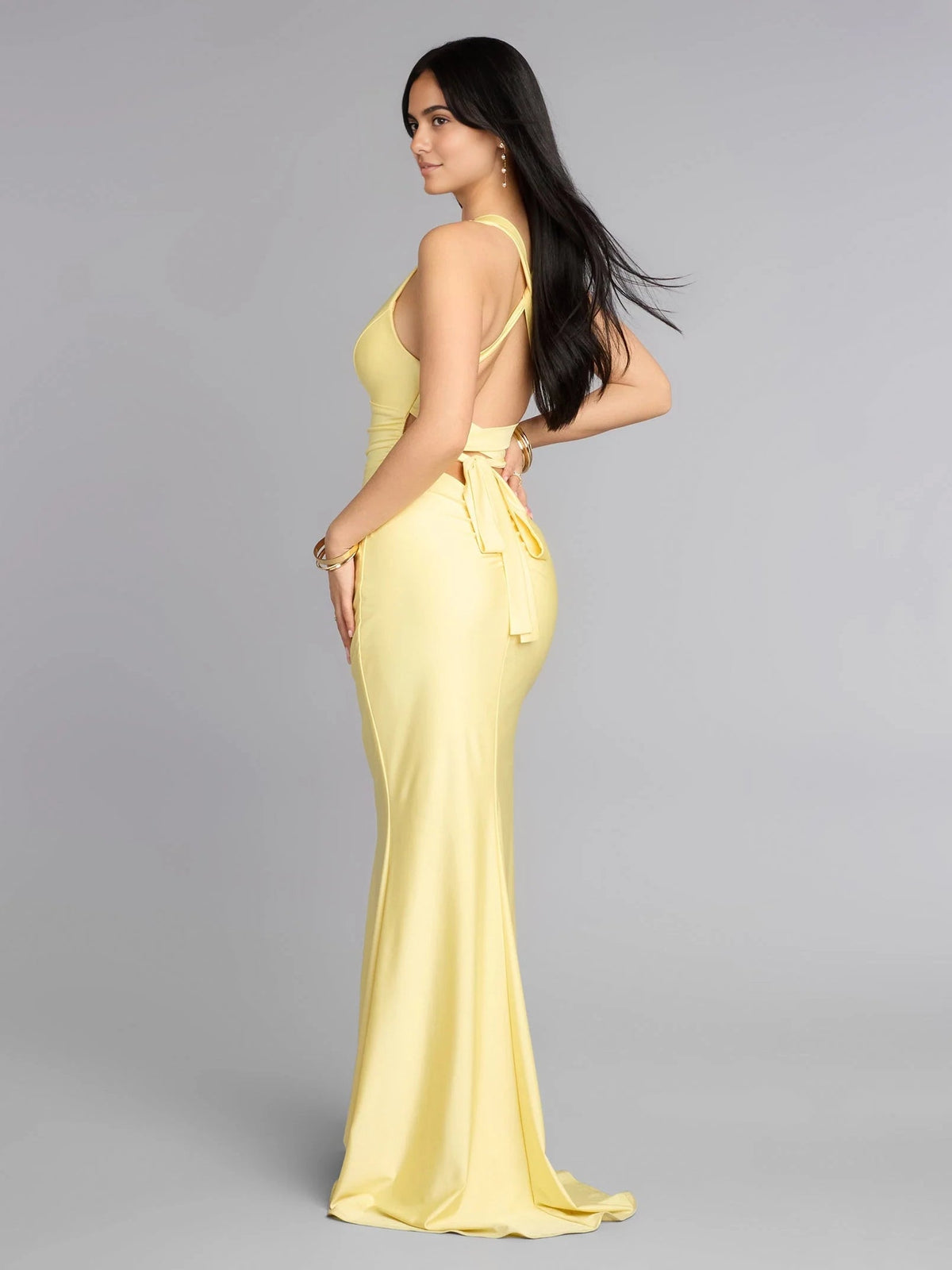 Pale lemon ruched V-neck mermaid maxi prom dress shown from the side with tie detail