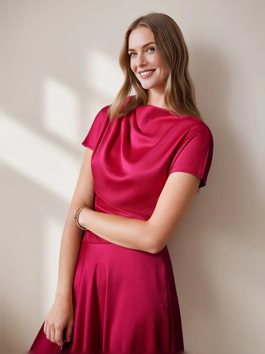 Hot pink satin cowl-neck dress with gathered waist, short sleeves and side drape.
