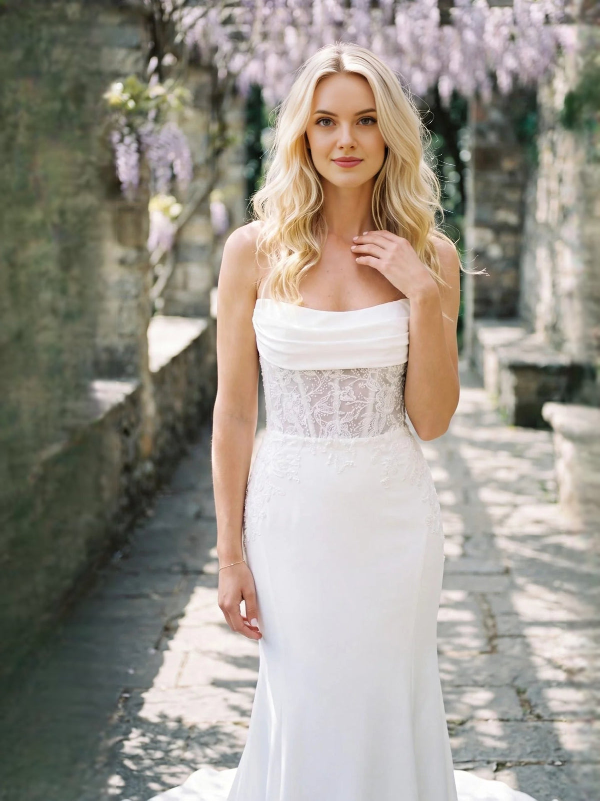 Ivory strapless lace corset wedding dress with draped neckline and fitted mermaid skirt