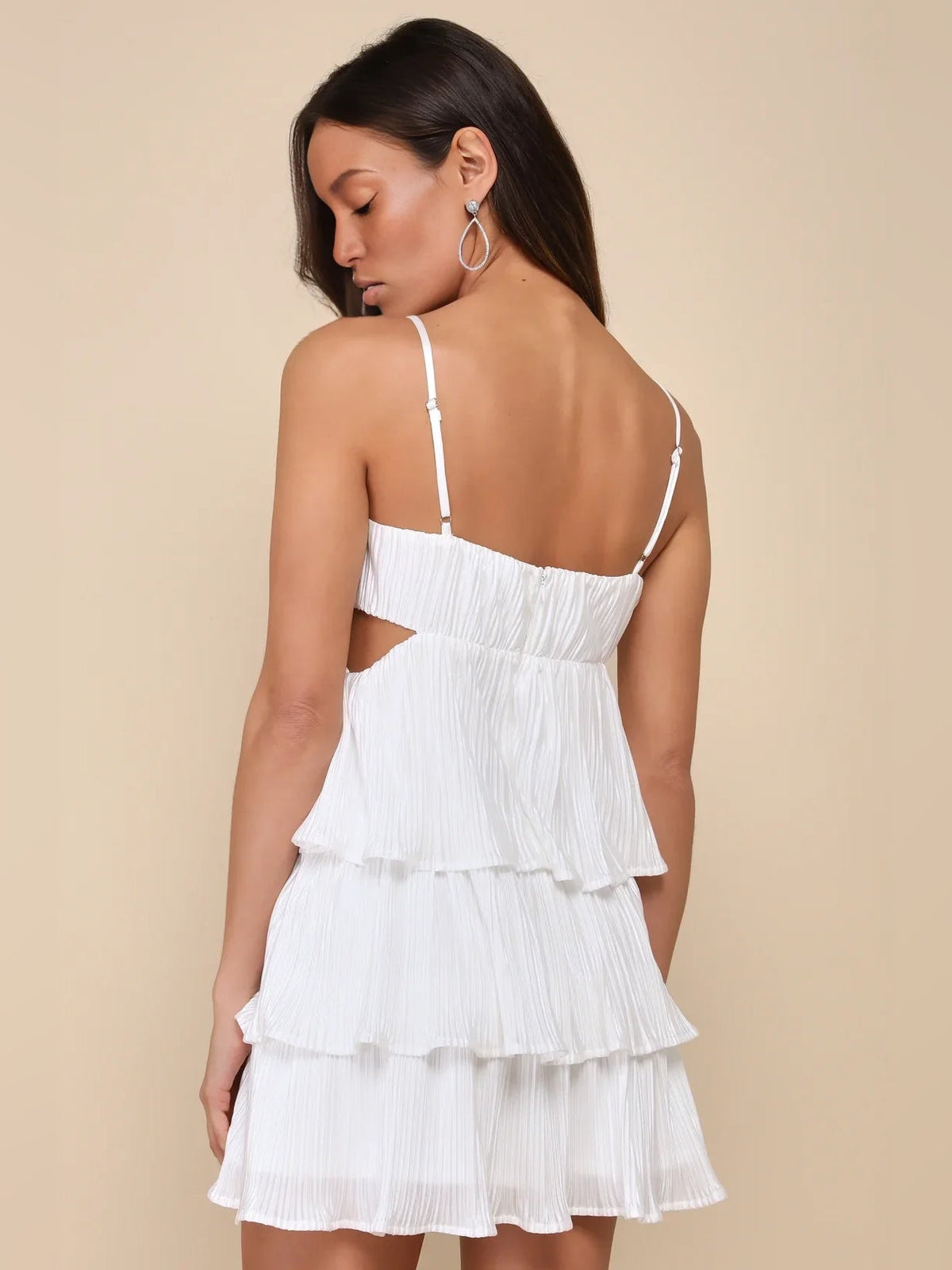 White satin mini dress with tiered ruffles and low back cut-out straps