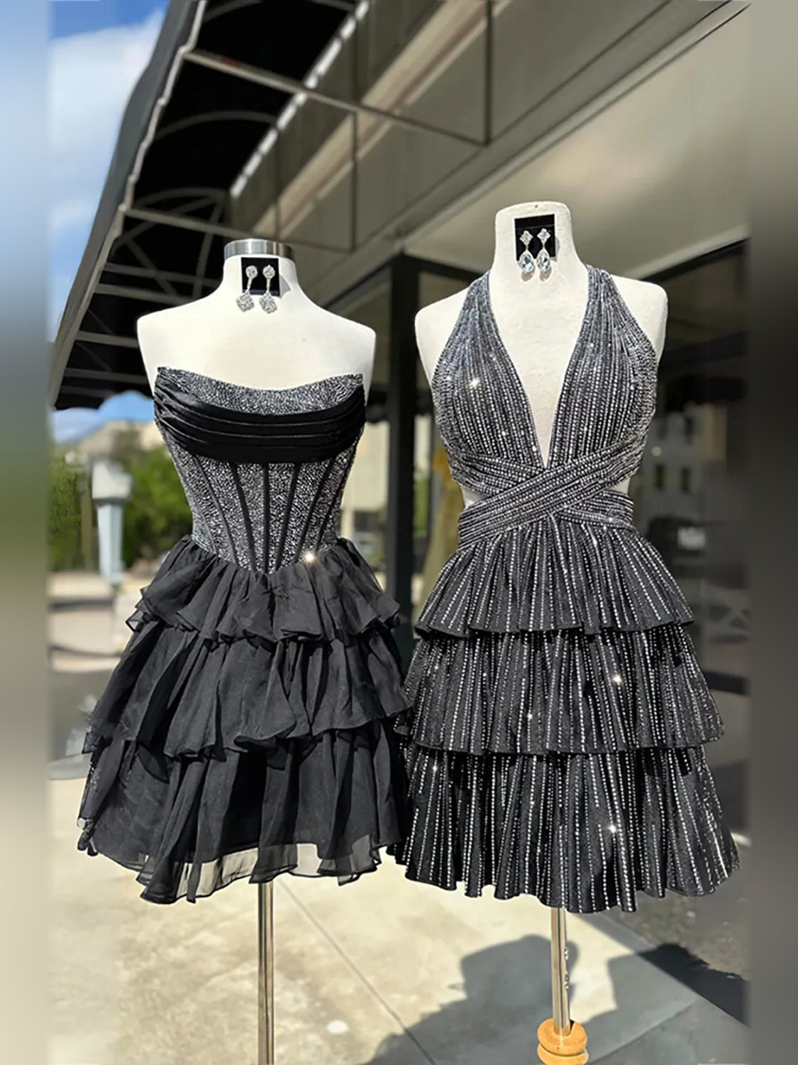 Corset-style tiered mini dresses on mannequins, black and silver sequin ruffle skirts
