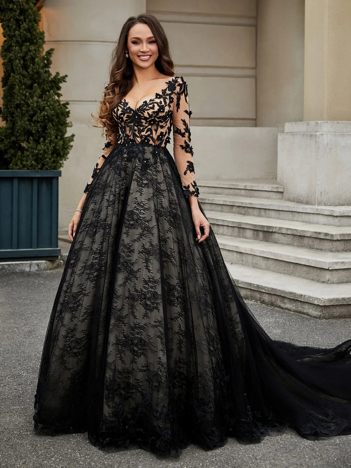 Black V-neck tulle wedding dress with floral applique bodice and flowing A-line train