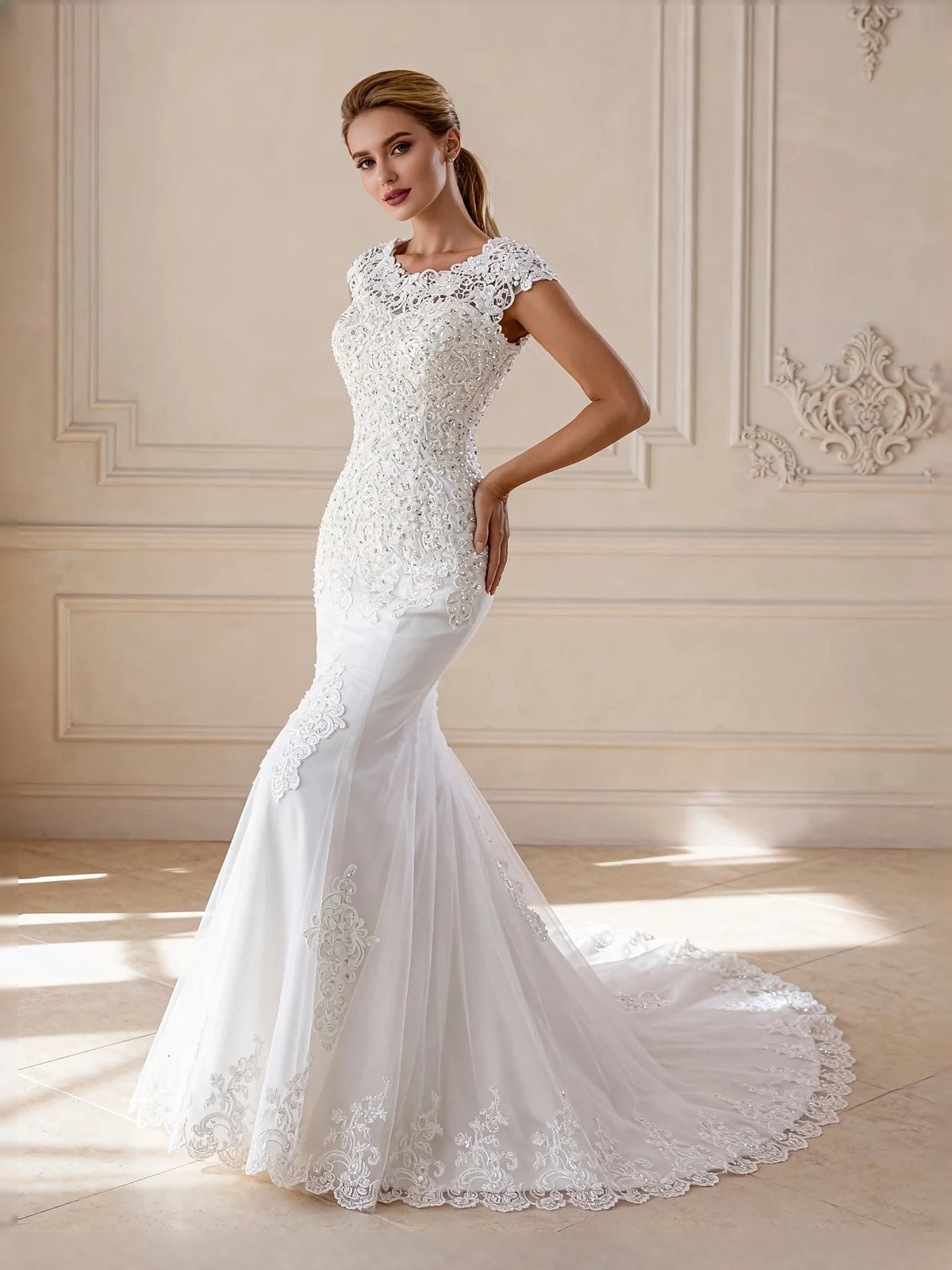 Ivory lace mermaid wedding dress with sleeveless bateau yoke and scalloped tulle hem