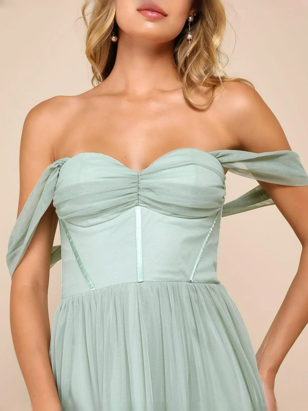 Mint green sweetheart corset-style bodice with off-shoulder draped sleeve detail