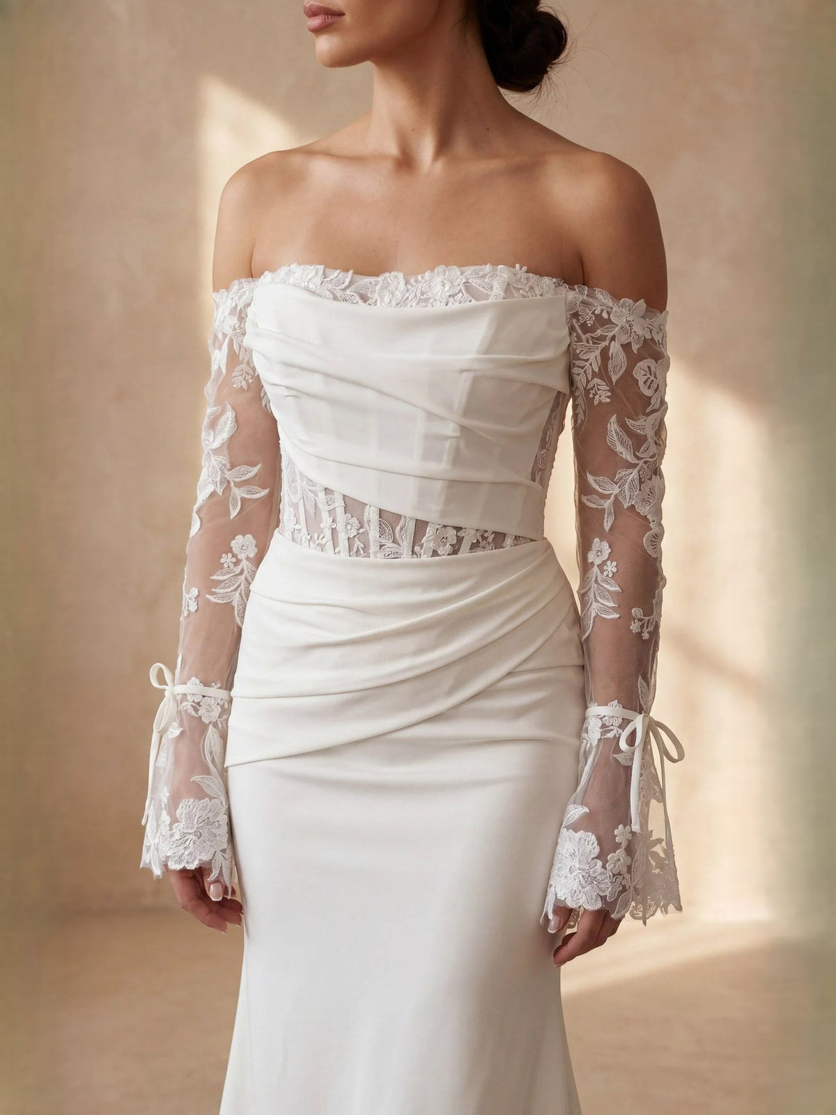 Ivory off-shoulder lace-sleeve bodice and draped satin mermaid wedding dress