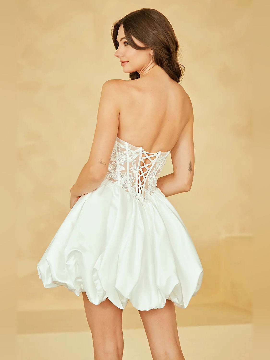 Ivory satin mini dress back view with corset-style lace detailing and flared skirt