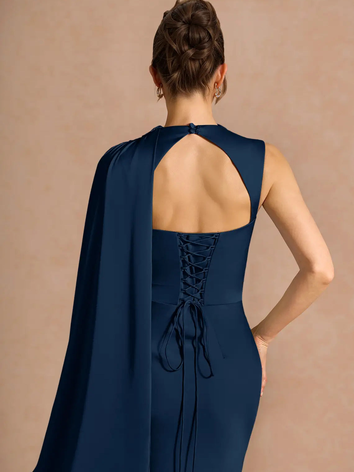 Navy open-back formal dress with lace-up corset back and draped shoulder