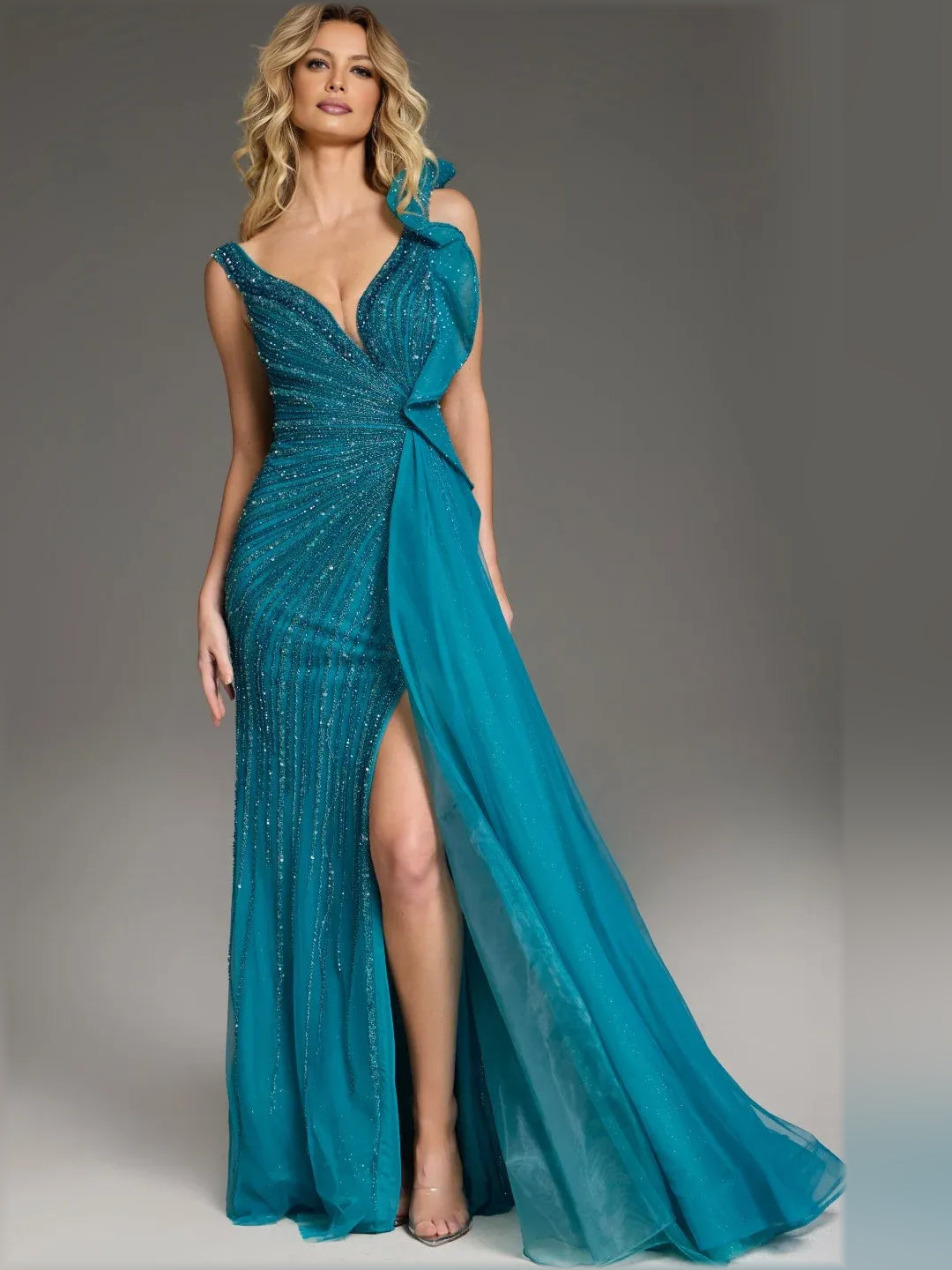 Teal sleeveless formal gown with V-neck, ruffled shoulders, and flowing slit skirt
