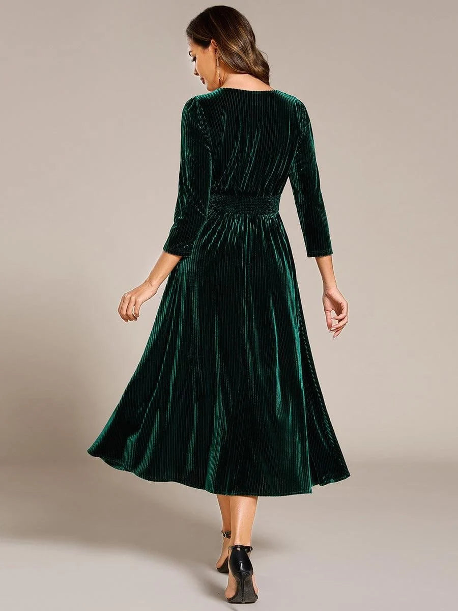 Dark green velvet V-neck A-line midi dress, back view with long sleeves