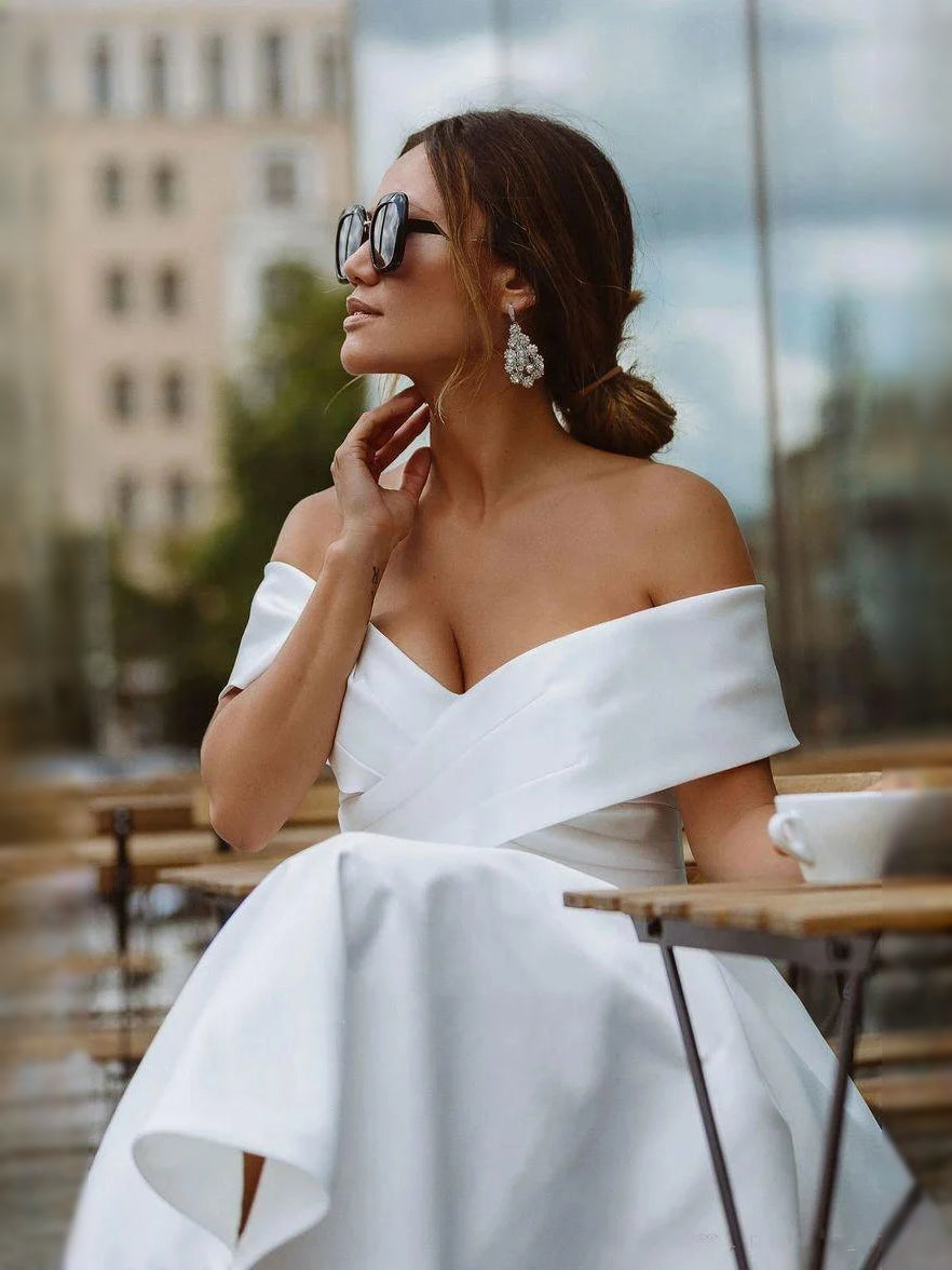 White satin off-shoulder sweetheart wedding dress with gathered bust and smooth bodice