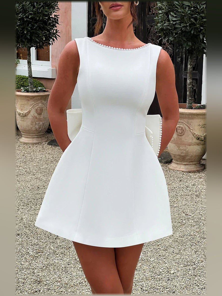 White sleeveless mini formal dress with beaded neckline and fitted waist A-line