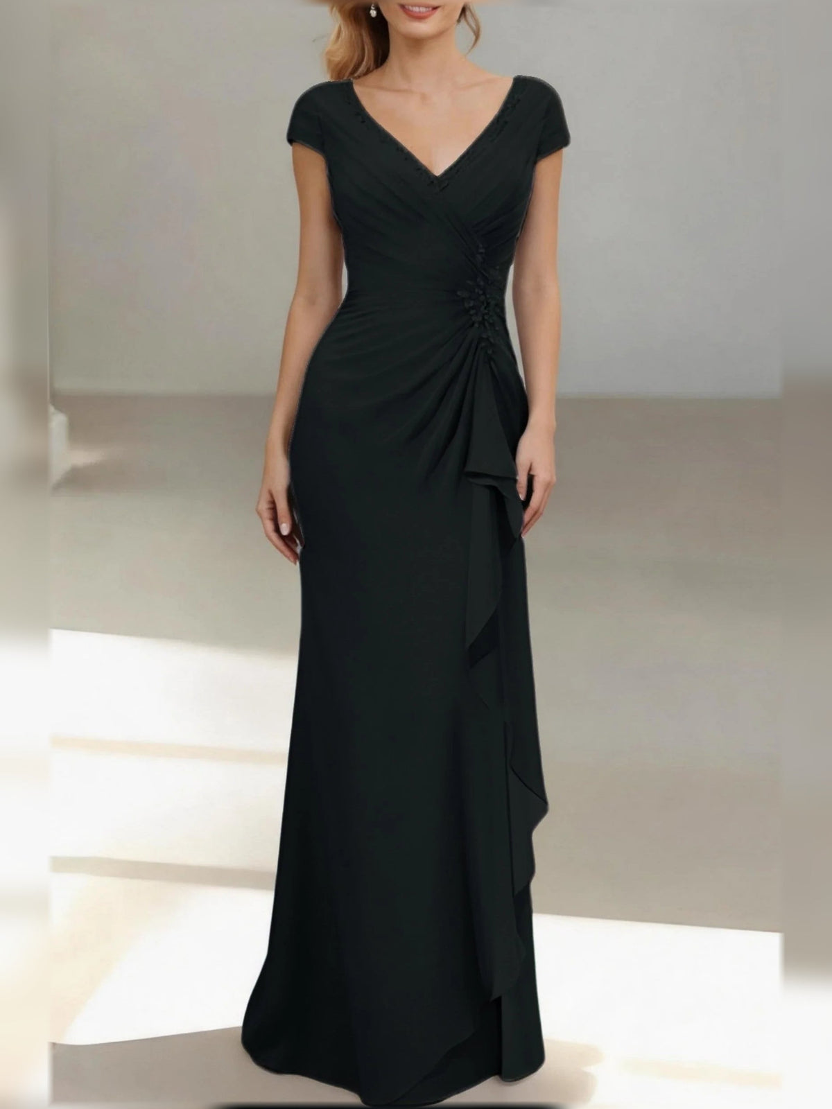 Black V-neck ruched mermaid gown with cap sleeves and draped ruffle skirt