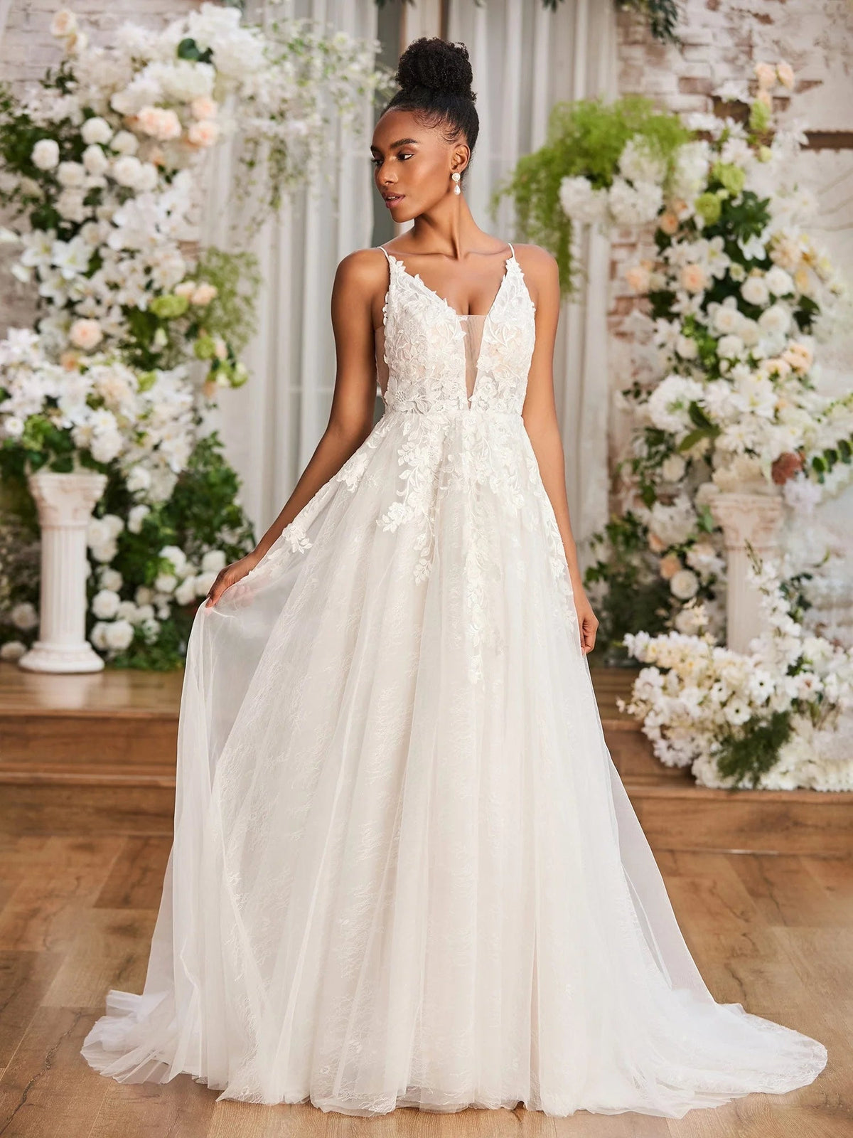 Ivory sleeveless V-neck A-line wedding dress with lace appliques, floor-length tulle